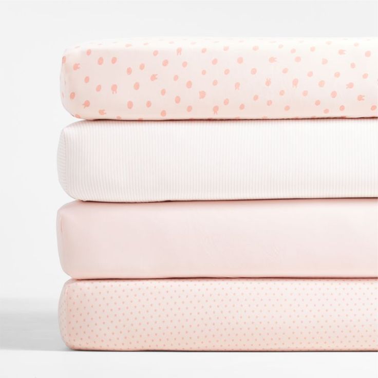 three sheets stacked on top of each other in pink and white polka dot print fabric