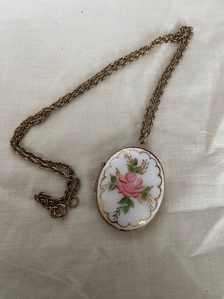 This is a vintage handpainted enamel locket. It is on a 24 inch chain and is in good vintage condition. Measurements of locket are in picture. Oval Enamel Locket Necklace, Oval Locket Necklace In Enamel, Vintage Oval Necklace With Adjustable Chain, Vintage Keepsake Necklace With Adjustable Chain, Vintage Necklaces With Adjustable Chain For Keepsake, Vintage White Enamel Necklaces, Vintage Cameo Jewelry In Enamel, Vintage Cameo Enamel Jewelry, Vintage Enamel Cameo Jewelry