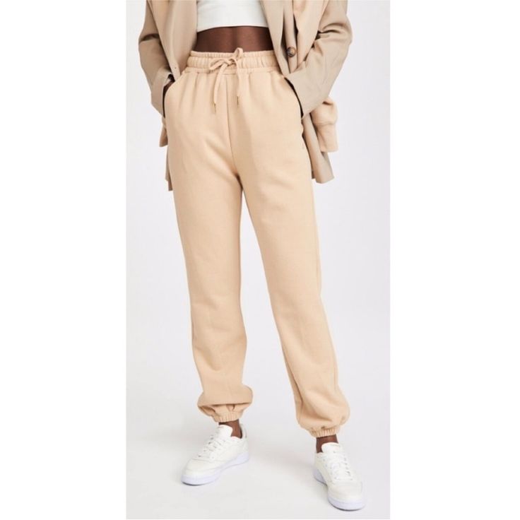 Weworewhat Revolve Sweatpants Brand New With Tag Size Medium Retail $90 100% Cotton Color Tan Elastic Waist And Drawstring Pockets Measurements (Measured Flat Across In Inches) Waist 14 Rise 14 Inseam 29 Beige Relaxed Fit Athleisure Bottoms, Beige Athleisure Bottoms With Ribbed Waistband, Beige Athleisure Pants With Elastic Waistband, Casual Fall Sweatpants With Pockets, Fall Season Elevated Casual Joggers With Pockets, Loosely Fitted Pants For Elevated Casual Fall Fashion, Trendy Straight Leg Sweatpants For Fall, Trendy Sweatpants With Elastic Waistband For Fall, Comfortable Fall Bottoms With Elastic Cuffs