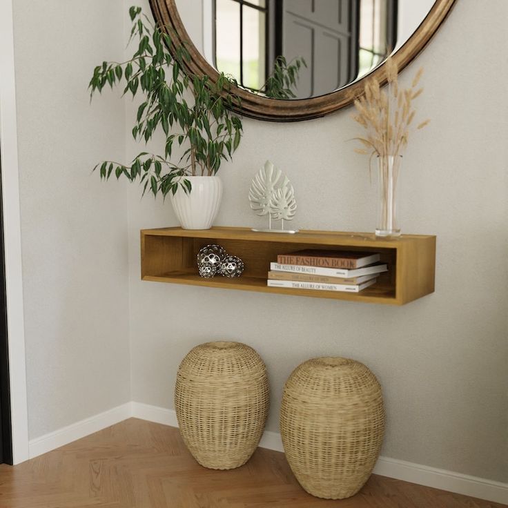 there is a mirror on the wall next to two stools and a plant in front of it