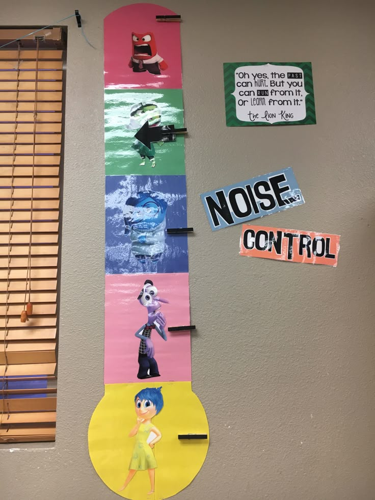 a bulletin board with pictures and stickers hanging on it's wall next to a window