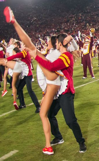 the cheerleaders are dancing on the field