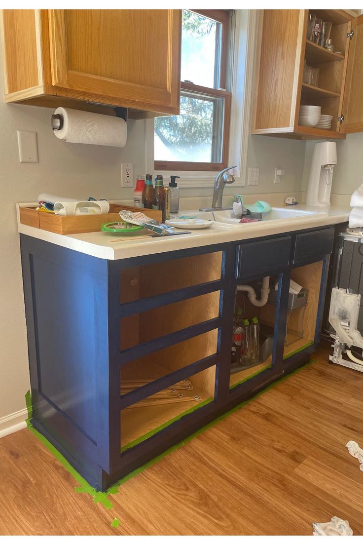 In progress pictures painting the lower cabinets navy. The drawers and cabinet doors are removed. Navy And White Kitchen Cabinets, Navy Blue And White Kitchen, White Kitchen Cabinet Design, Navy And White Kitchen, Blue And White Kitchen Cabinets, Navy Kitchen Cabinets, Two Toned Kitchen Cabinets, Navy Blue Kitchen Cabinets, White Kitchen Cabinet