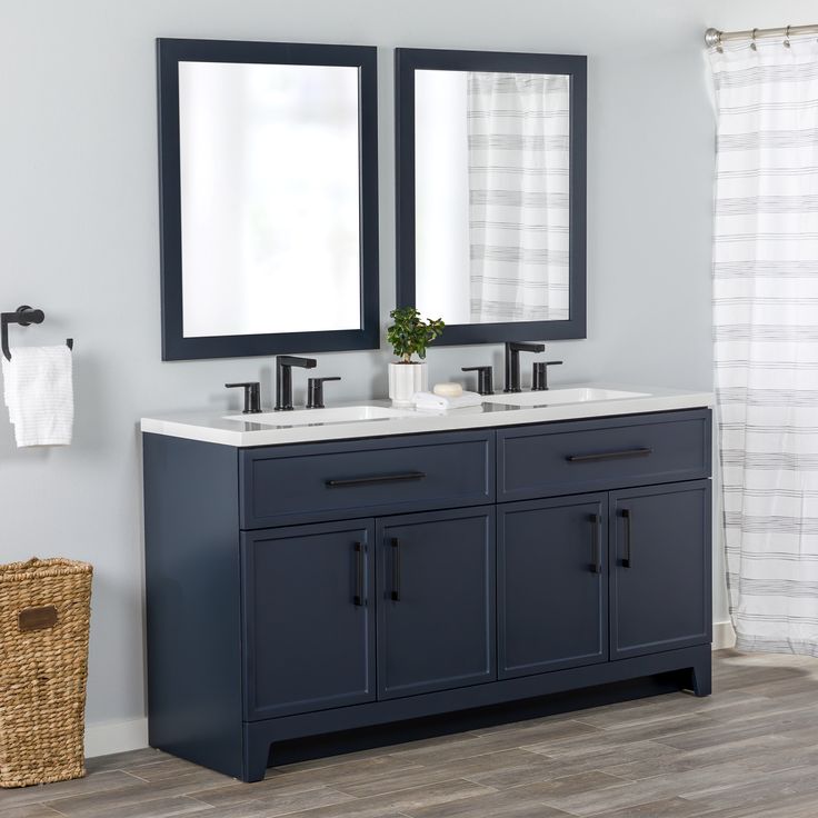 a bathroom with two sinks and mirrors on the wall