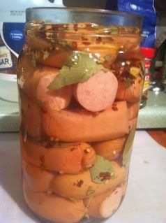 a jar filled with pickles sitting on top of a counter