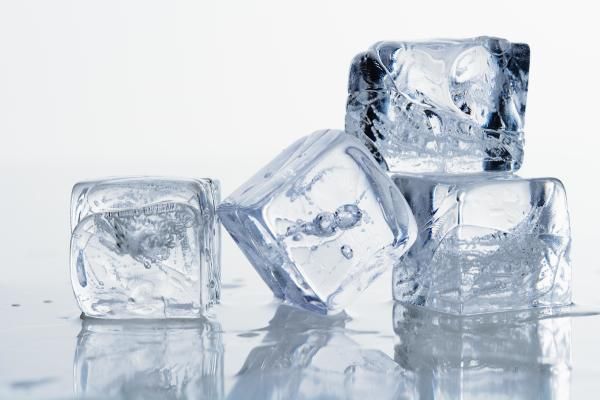 three ice cubes sitting on top of a table