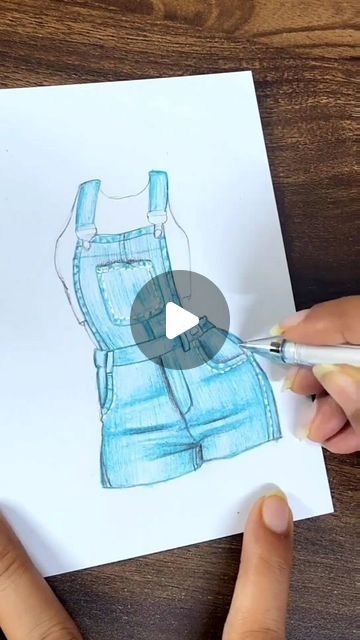 someone is drawing a blue jean overall on paper