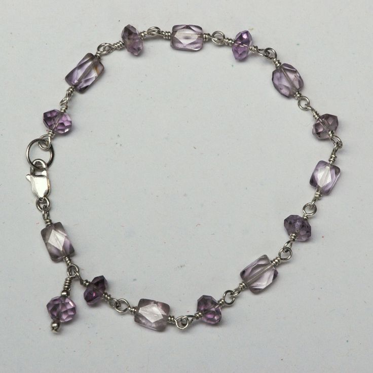 Small faceted amethyst beads wired together with sterling silver wire and a sterling silver lobster clasp A dainty little bracelet with an amethyst charm at the clasp. 7 1/4" long. Free US shipping! Free gift wrap! Cheap Handmade Lavender Jewelry, Purple Gemstone Beaded Bracelets In Sterling Silver, Faceted Sterling Silver Beaded Bracelets For Jewelry Making, Silver Amethyst Beaded Bracelets With Faceted Beads, Adjustable Faceted Sterling Silver Crystal Bracelet, Silver Amethyst Beaded Bracelet With Faceted Beads, Faceted Sterling Silver Bracelet, Adjustable Amethyst Jewelry With Lobster Clasp, Silver Amethyst Bracelets With Faceted Beads