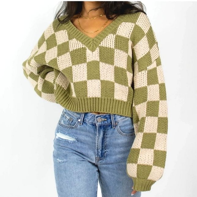 a woman wearing a green and white checkered sweater