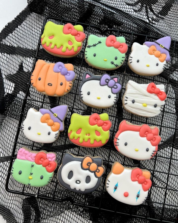 hello kitty decorated cookies are sitting on a wire rack