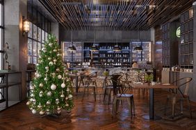 an empty restaurant with tables and chairs decorated for christmas