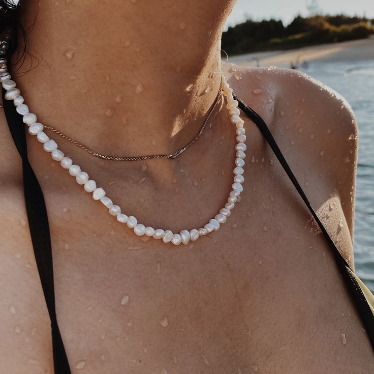 🐚Material: Freshwater Pearls, 14K Gold Plated 🐚Necklace length: 40cm with extension  The perfect beach 🏖and tropical accessory for the SUMMER!! The necklace is made with freshwater pearls with 14k gold plated extension. Pearl Necklace is also suitable for daily wear and special occasions; an ideal gift for any gender!  📫Next Day Dispatch, 🌍Worldwide FREE Shipping  * It will be shipped the Next Working Day after you placed the order. * Only process the orders from Monday to Friday. * Worldwi Pearl Pendant Necklaces For Beach, Adjustable Pearl Pendant Jewelry For Beach, Elegant Necklace With Lobster Clasp For Vacation, Adjustable Pearl Charm Necklaces For Vacation, Adjustable Pearl Charm Necklace For Vacation, Gold Necklace With Pearl Pendant For Summer, Summer White Necklaces With Pearl Pendant, White Pearl Pendant Necklace For Summer, Summer White Necklace With Pearl Pendant