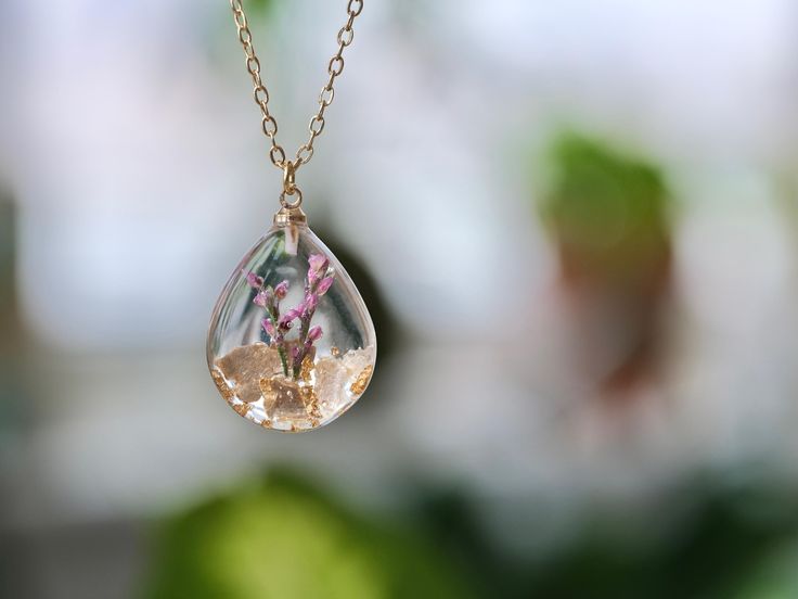 This necklace features Gladiolus, the birth flower for August, carefully preserved in a clear resin pendant. Gladiolus is symbolic of strength of character, faithfulness, moral integrity, and remembrance, making this necklace a perfect personalized birthday gift. Material: 14k gold filled chain and components or Silver, Resin Flower: Real Pressed Flower Chain Length: 18" (45cm)  Pendant Width: 0.79" (2cm) Pendant Height: 0.98" (2.5cm) Every pieces is made by hand and unique, therefore each piece Spiritual Necklaces With Pressed Flowers As Gift, Spiritual Style Necklace With Pressed Flowers As A Gift, Clear Flower-shaped Birth Flower Jewelry, Clear Flower Shaped Birth Flower Jewelry, Nature-inspired Clear Jewelry For Gifts, Clear Nature-inspired Jewelry For Gift, Nature-inspired Clear Jewelry Gift, Clear Flower Pendant Necklace As Gift, Clear Necklaces With Pressed Flowers As A Gift