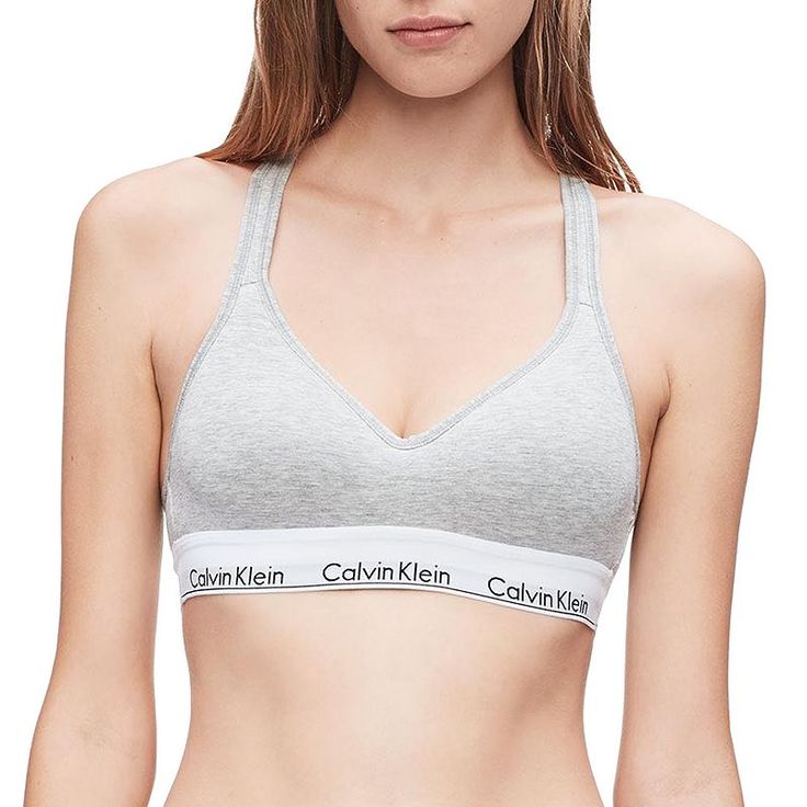 An updated Calvin Klein icon. Cut in a sports bra silhouette and crafted with a super-soft, cotton-blend construction, this women's bralette is perfect for low-impact workouts or everyday wear. An updated Calvin Klein icon. Cut in a sports bra silhouette and crafted with a super-soft, cotton-blend construction, this women's bralette is perfect for low-impact workouts or everyday wear. Padded cups Crossback straps with keyhole opening Lift construction Calvin Klein logo bandFIT & SIZING Easy Fitted Calvin Klein Athleisure Tops, Sporty Cotton Sports Bra With Built-in Bra, Cotton Athleisure Sports Bra With Built-in Bra, Calvin Klein Athleisure Tops For Sports, Seamless Cotton Bra, Stretch Cotton Bra With Light Support, Stretch Cotton Bra With Removable Pads, Cotton Stretch Bra With Removable Pads, Cotton Bra With Removable Pads And Stretch Fit