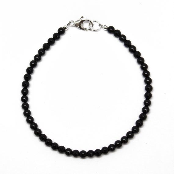 Black Onyx beads are hand strung to form this classic single strand bracelet.  The beads are tiny measuring about 3.0mm.  This is a beautifully tiny, and delicate onyx bracelet.  You could wear this alone or stack with other bracelets for a layering effect.  I have hand strung these beads using a premium beading wire that has beautiful drape and it fastens with a sterling silver or gold filled lobster clasp.  The bracelet is available in 6.0"  to 8.0" lengths. Select your size at check out.Match