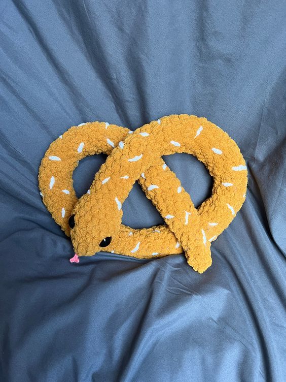 two stuffed animals are laying next to each other on a bed with the peace sign made out of them