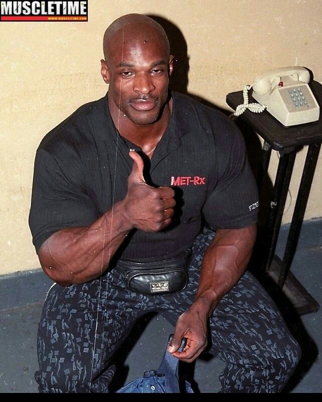 a man sitting on the floor with his thumbs up