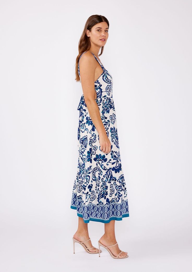 A sweet summer midi dress designed in a blue and white floral print. Floral print Sleeveless Mid-length Tiered skirt with contrast border print Square neckline Contrast stitch details Adjustable tie at the back Bohemian summer midi dress Feel the summer breeze in our charming midi dress! Featuring a blue-white floral print, square neckline, and a delightful tie-back accent. Perfect for sunny strolls and garden parties. Model is 5'9, wearing a size S.Style: I-73512W-SRU-BB Beach Halter Neck Midi Dress With Floral Print, Printed Midi Length Summer Sundress, Printed Midi Length Sundress For Summer, Printed Midi Sundress For Summer, Summer Midi Sleeveless Dress With Floral Print, Printed Sundress Midi Dress For Brunch, Printed Sundress For Brunch, Spring Paisley Print Midi Dress For Vacation, Spring Vacation Midi Dress With Paisley Print