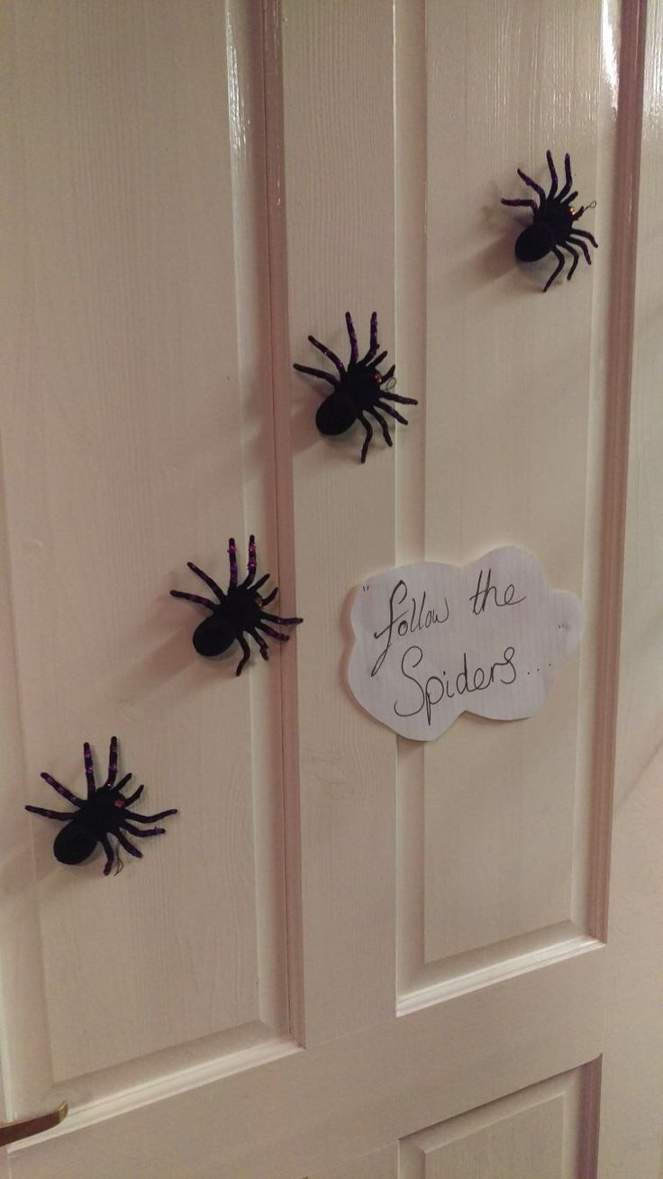 the door is decorated with fake black spider's and says tales of the spiders