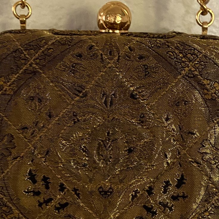 Add A Touch Of Glamour To Your Outfit With This Stunning Authentic Vintage Gold Evening Clutch From Chanel. The Shoulder Strap Is Long And Stylish, While The Gold Exterior In Metallic Fiber And Hardware Create A Chic Look. The Lambskin Lining Adds A Soft Touch, While The Gold Lining Color Matches Perfectly With The Exterior. This Elegant Shoulder Bag Is Perfect For Any Occasion, Be It A Wedding, Party, Formal Event, Or A Day At Work. The Chanel Logo Is Prominently Displayed, Adding To The Bag's Sophistication. Don't Miss Out On The Opportunity To Own A Piece Of Fashion History With This Gorgeous Vintage Chanel Shoulder Bag. Chanel Evening Bags, Festive Formal Evening Bag With Gold Embroidery, Formal Festive Evening Bag With Gold Embroidery, Designer Embroidered Evening Bag, Formal Rectangular Evening Bag With Gold Embroidery, Classic Gold Evening Bag For Formal Occasions, Elegant Festive Evening Bag With Gold Embroidery, Elegant Clutch Evening Bag For Vintage Events, Elegant Rectangular Evening Bag With Gold Embroidery