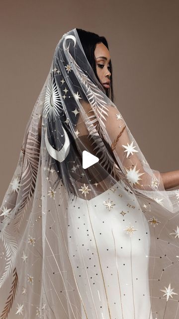 a woman wearing a veil with stars on it