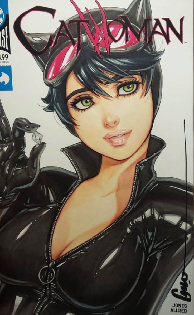 a person holding up a comic book with catwoman on it