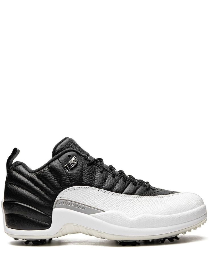 a black and white tennis shoe on a white background