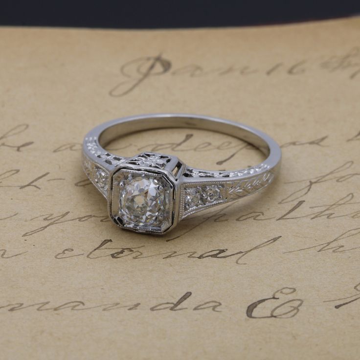 "For your consideration is this antique platinum diamond ring featuring a square pierced filigree setting with very fine milgrain accents. The ring features a .63 carat Old Mine cut diamond securely bead set in the ring head while Old European and single cut diamonds add further embellishment. The sweet simplicity of this ring is compounded by an understated ornateness completed with the most dainty of details. Item details: Metal - Platinum Finger Size - 6.75 Band Width - 3.2 mm Head Size (leng Wedding Ring Redesign, Vintage Engagement Ring Settings, Platinum Diamond Ring, Vintage Jewellery Rings, Old Mine Cut Diamond, Ring Settings, Platinum Diamond Rings, Bead Set, Antique Engagement