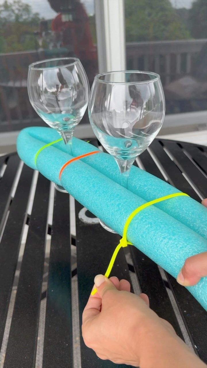 two wine glasses sitting on top of a table next to a rolled up piece of paper