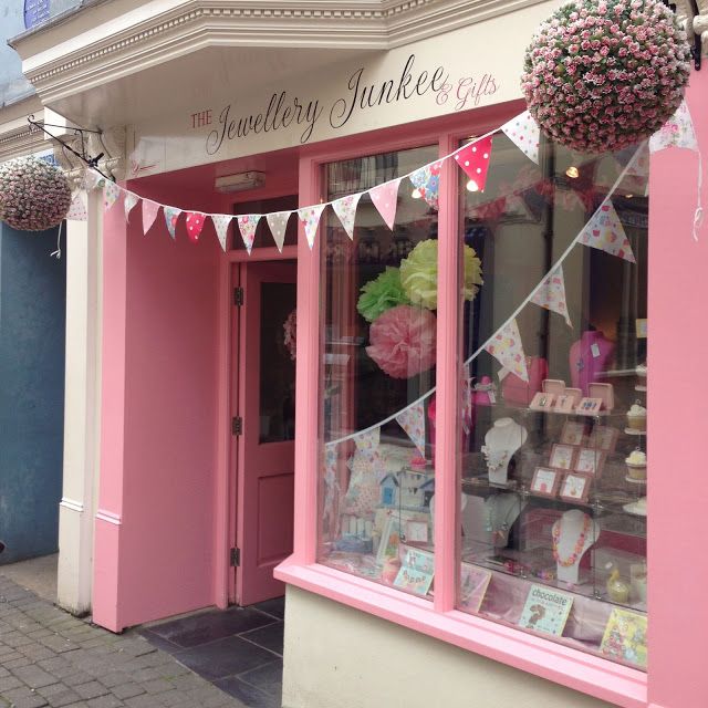 a pink store front with bunting and decorations