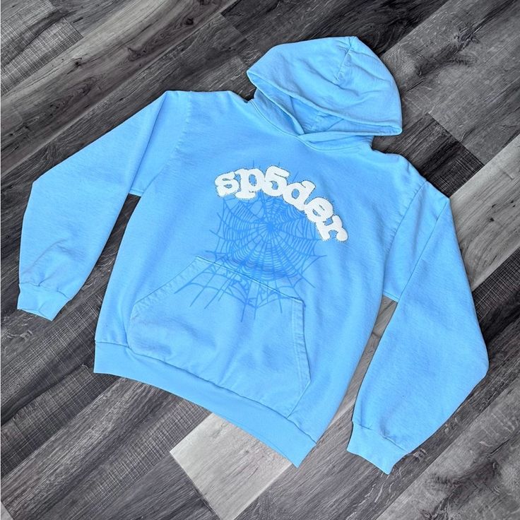 Brand New Size M Blue Glitter Sweater, Blue Sp5der Hoodie, Blue Hooded Sweatshirt For Streetwear, Light Blue Graphic Print Sweatshirt For Winter, Sporty Light Blue Hoodie For Streetwear, Winter Light Blue Graphic Sweatshirt, Blue Hoodie With Drawstring For Streetwear, Blue Graphic Print Hoodie For Fall, Blue Adjustable Hood Sweatshirt For Streetwear