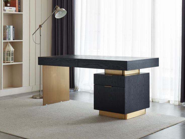 a black and gold desk sitting in front of a book shelf with books on it