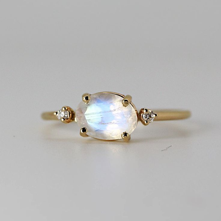 Fine Jewelry Oval Moonstone Ring With Rose Cut Diamonds, Fine Jewelry Yellow Gold Moonstone Ring, Heirloom Oval Moonstone Jewelry, 14k Gold White Moonstone Oval Cabochon Ring, Delicate Oval Moonstone Ring In 14k Gold, White Oval Cabochon Moonstone Ring In 14k Gold, Yellow Gold Oval Moonstone Ring, White Moonstone Oval Cabochon Ring In 14k Gold, Oval Moonstone Ring With Rose Cut Diamonds For Gift