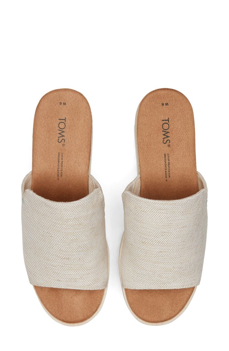 Braided jute adds beachy charm to the sporty-chic midsole of this canvas wedge sandal set on a lightweight sawtooth sole. 2 1/4" heel; 1 1/4" platform (size 8.5) OrthoLite® Eco™ X-40 Hybrid footbed Cushioned footbed Textile upper and lining/synthetic sole Imported TOMS is a Certified B Corporation, which meets standards for verified social and environmental performance, public transparency and legal accountability to create a more inclusive and sustainable economy TOMS gives a minimum of one-thi Casual Slip-on Wedge Sandals With Textured Sole, Summer Textile Sandals For Vacation, Casual Espadrille Wedge Slip-on Sandals, Beige Textile Sandals For Vacation, Beige Textile Sandals For Summer, Summer Beige Textile Sandals, Summer Espadrille Wedge Sandals With Textured Sole, Beige Sandals With Woven Sole, Beige Textile Sandals With Woven Sole