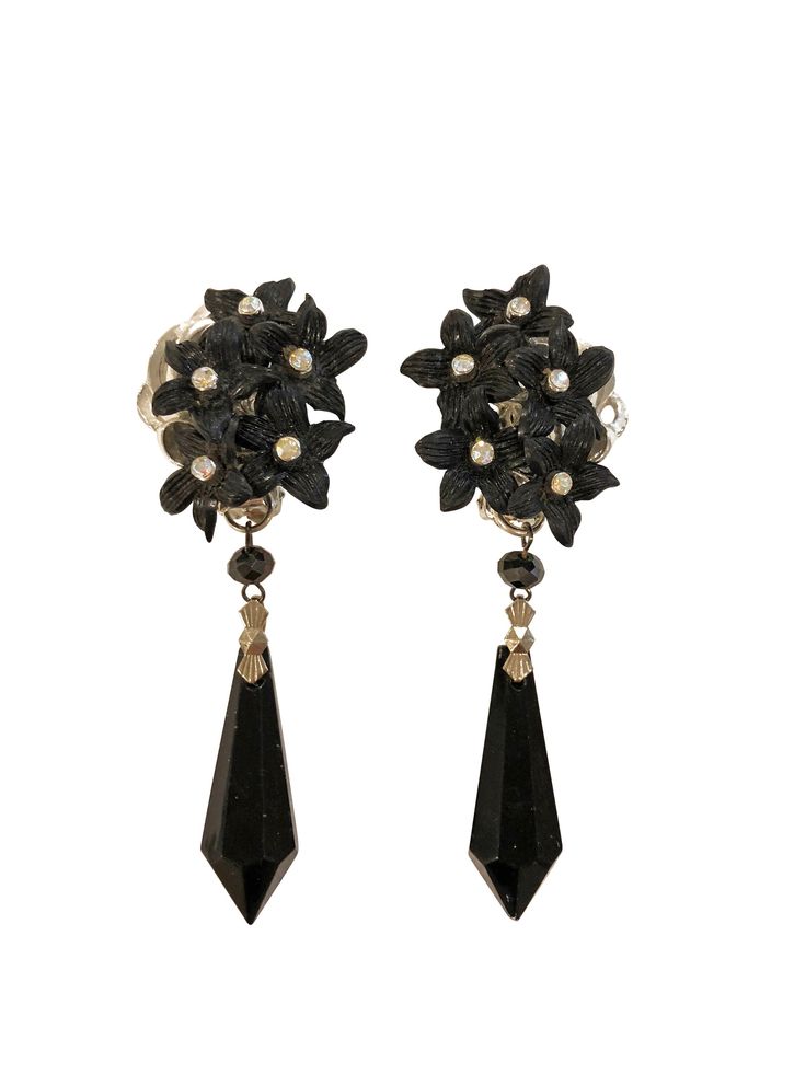 Stunning statement danglers for your pretty lobes. Featuring vintage black glass chandelier pieces hand-picked in NYC. Vintage pieces are comprised of hand selected vintage collected from Australia, UK and/or America. The elements are then woven together in Australia with Swarovski or other elements to create something modern and one-of-a-kind. Vintage wear. Sitting beautifully on the ear at 8.5cm in length and 3.5cm across. Clip back fastening. Weight approx 23grms Evening Metal Clip-on Chandelier Earrings, Clip-on Metal Chandelier Earrings For Evening, Vintage Teardrop Crystal Earrings For Formal Occasions, Vintage Crystal Teardrop Earrings For Formal Occasions, Vintage Black Dangle Jewelry, Victorian Dangle Chandelier Earrings For Parties, Victorian Chandelier Dangle Earrings For Party, Vintage Black Earrings For Wedding, Evening Dangle Crystal Clip-on Earrings