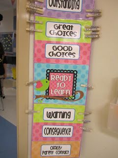 a bulletin board hanging on the wall in a hallway with words and phrases attached to it