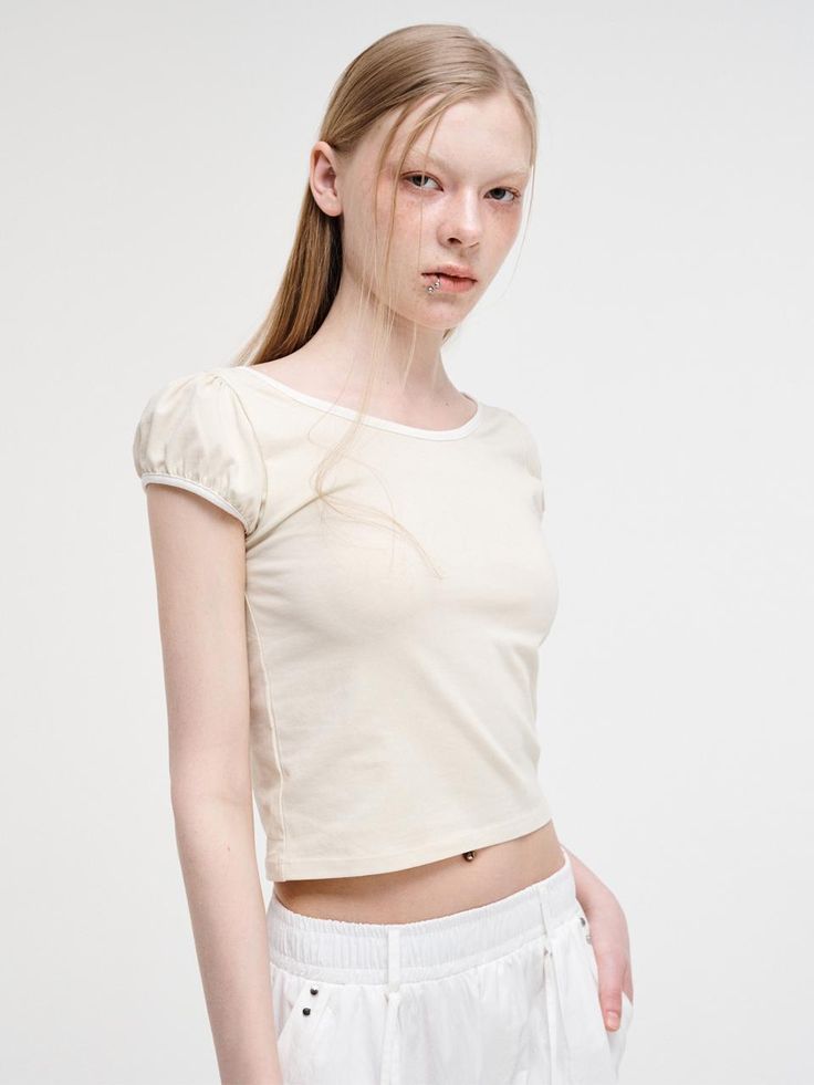 This is a trendy and feminine top by ETMON that is made out of high quality and sturdy material. With distinctive mood of the design and modern feminine look, you can style it for your casual daily outfit.- Wide round neckline and slim silhouette- Strap with hole slits on the back- Feminine and trendy look Trendy Cream Summer T-shirt, Solid Color Trendy Crop Top, Fitted Cream T-shirt With Crew Neck, Trendy Crop Top In Solid Color, Chic Fitted T-shirt For Day Out, Trendy Fitted Short Sleeve Crew Neck Top, Fitted Solid Color Top For Spring, Trendy Cotton Tops For Spring, Beige Stretch Crew Neck Crop Top