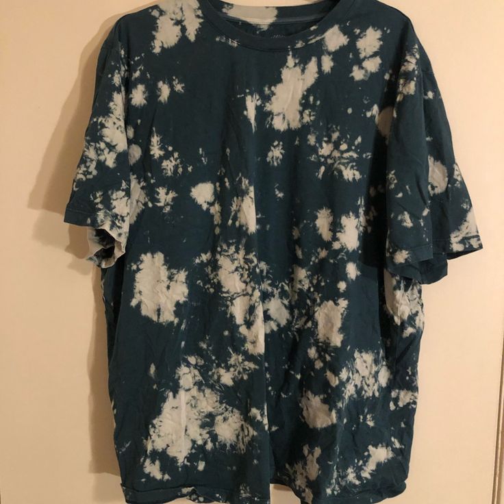 a blue and white tie dye shirt hanging on a wall