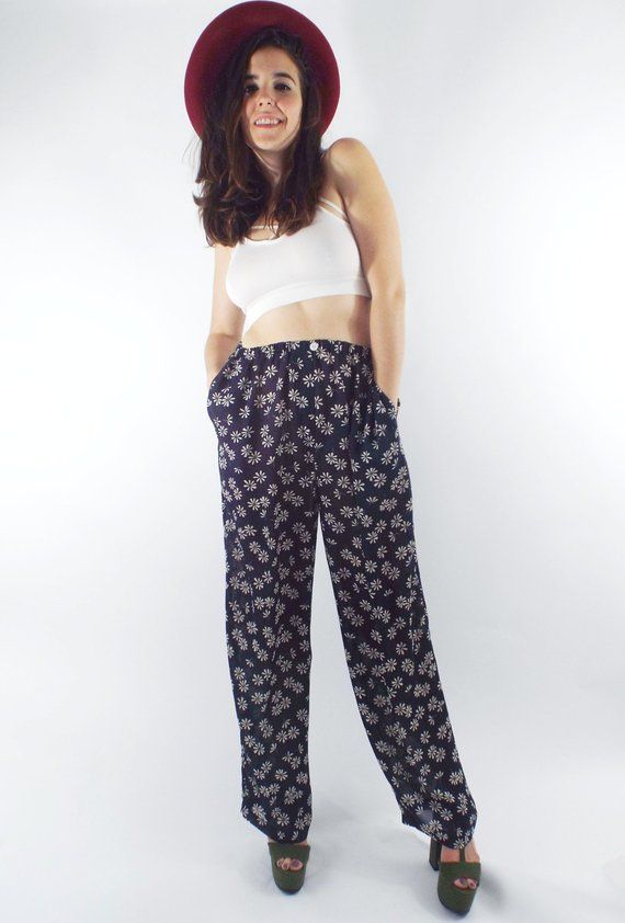 Vintage 90s Express pants in a nice, navy blue color with an allover off white daisy print. Pants are slightly sheer and have an elastic waist, pockets (!!!) and a single decorative button and faux fly in front. Model wears a small.Label: ExpressDecade: 1990sCondition: Very goodMaterials: 100% PolyesterMarked Size: LargeTrue Size: Small/Medium (Model wears a small, waist is elastic)Measurements: 26 inch waist (elastic)42 inches longCheck out our full collection at totalrecallvintage.com and foll Floral Print Summer Pants For Daywear, Summer Floral Print Pants For Daywear, Casual Floral Print Pants, Casual Floral Print Pants For Daywear, Floral Print Full Length Loungewear Bottoms, Floral Print Full-length Loungewear Pants, Floral Print Straight Pants For Loungewear, High Waist Floral Print Loungewear Bottoms, Straight Pants With Floral Print For Loungewear