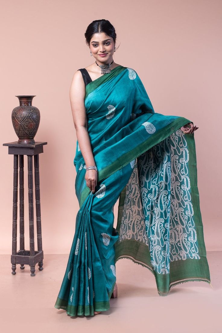 Sea green silk saree has almost become synonymous with your perfect evening wear. This mulberry silk is intricately designed in a combination of traditional and abstract paisley print sarees. Silk mark certified. COLOUR: Sea green and White  CRAFT: Hand block printing DIMENSIONS: Saree length 6.5 Mts., Saree width 1.14 Mts. Blouse piece inclusive.  NET QUANTITY: 1 pc saree PATTERN: Traditional and abstract paisley PRODUCT MATERIAL: Handwoven Pure Mulberry Silk saree PRODUCT TYPE: Saree with Blouse piece WEIGHT: 350 g  WASH INSTRUCTIONS: Dry cleaning is recommended for this product. Iron inside out. Do not bleach and expose this product to excessive heat and sunlight for long. Sea Green Saree Blouse Combination, Green Slub Silk Pre-draped Saree, Designer Green Cotton Silk Saree, Green Semi-stitched Pre-draped Saree In Slub Silk, Green Semi-stitched Slub Silk Pre-draped Saree, Semi-stitched Green Pre-draped Saree In Slub Silk, Designer Green Saree For Transitional Season, Festive Green Cotton Silk Saree, Green Silk Pre-draped Saree For Eid