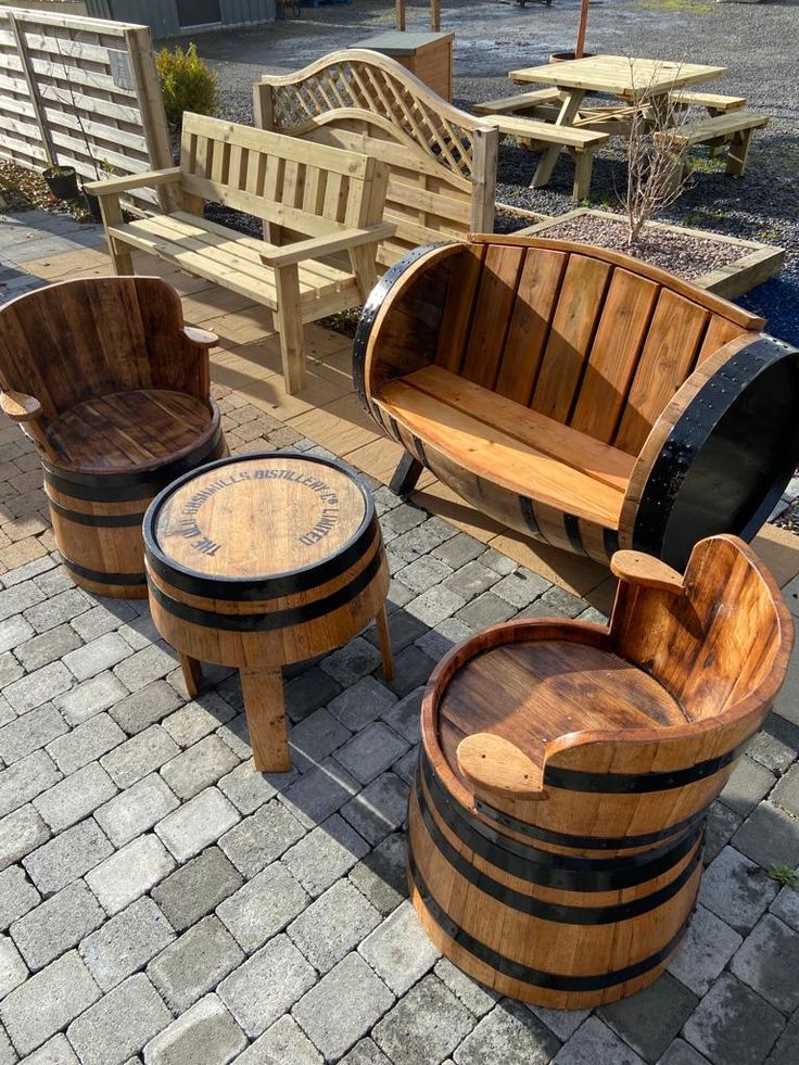 three wooden barrel chairs and two stools on a brick patio