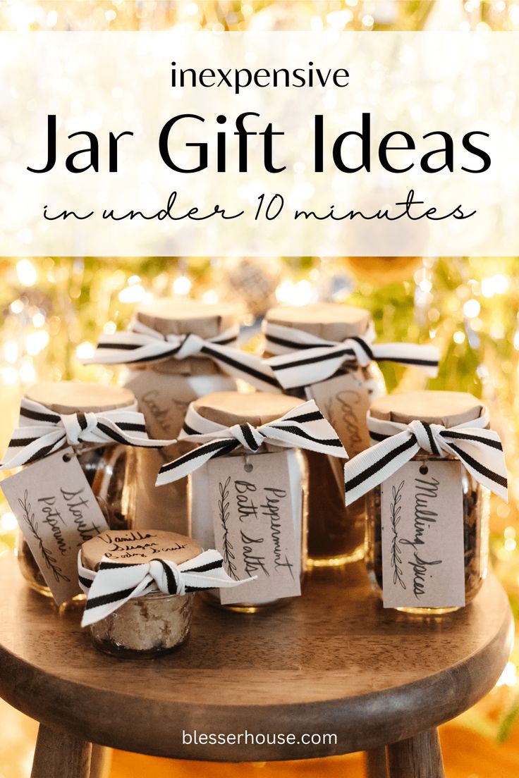 jars filled with jam sitting on top of a wooden table in front of a christmas tree