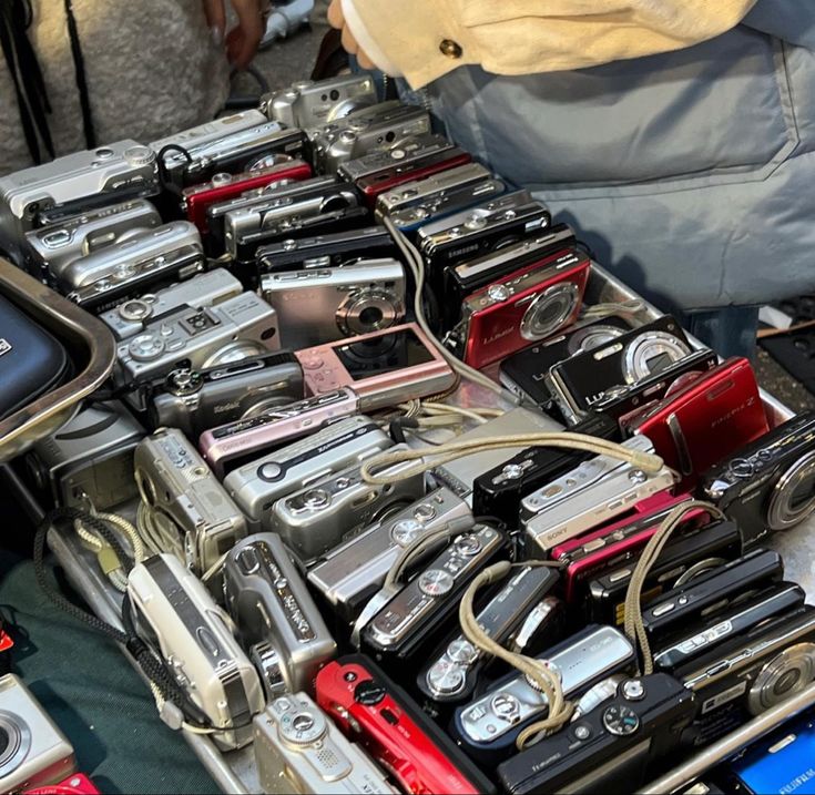 there are many different cameras on display in the case, and one is full of them