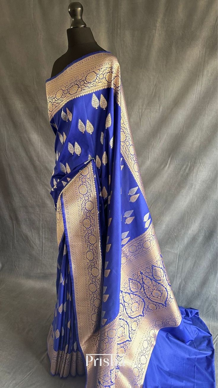 Experience timeless elegance in this blue katan silk saree, featuring sonarupa zari weaving in leaf design all over the body.  Blouse: Royal blue katan silk with zari border [unstitched] Blue Katan Silk Dupatta With Motifs, Blue Katan Silk Traditional Wear With Motifs, Blue Art Silk Saree With Traditional Drape, Blue Traditional Katan Silk Wear With Motifs, Blue Tussar Silk Dupatta With Motifs, Blue Traditional Wear With Motifs In Katan Silk, Blue Tussar Silk Saree For Diwali, Blue Silk Traditional Wear For Festivals, Blue Tussar Silk Saree With Zari Weaving