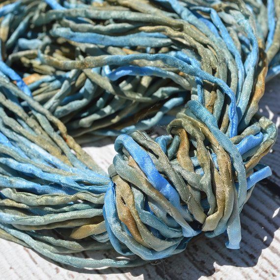 blue and brown braided fabric sitting on top of a wooden table