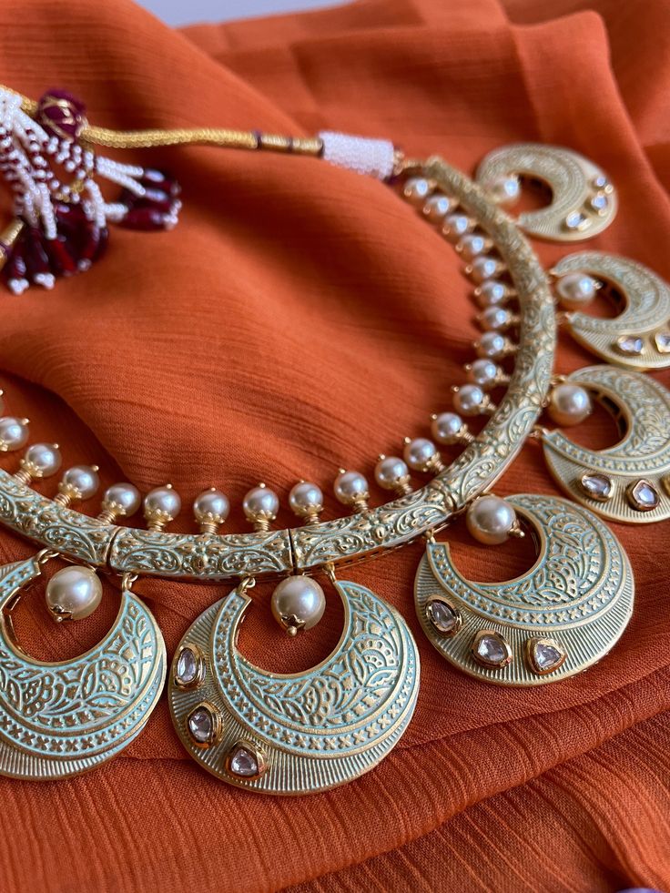 Gorgeous hasli style Rajasthani meenakari choker with kundan stones and matching earrings and tikka is the classiest piece of jewelry! This set is beautifully hand crafted and is very lightweight and versatile to wear! Meenakari Chandbali Sets For Festive Occasions, Diwali Temple Jewelry Sets With Meenakari, Navratri Meenakari Temple Jewelry Sets, Festive Meenakari Temple Jewelry Sets, Traditional Meenakari Chandbali Sets, Diwali Meenakari Temple Jewelry Sets, Festive Kundan Necklace With Meenakari, Round Kundan Necklace With Meenakari For Festivals, Festive Round Kundan Necklace With Meenakari