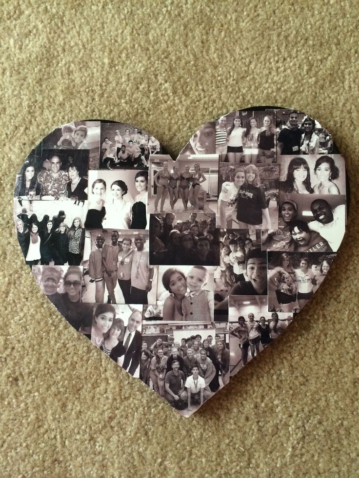 a heart - shaped photo collage is displayed on the floor in front of a carpeted wall