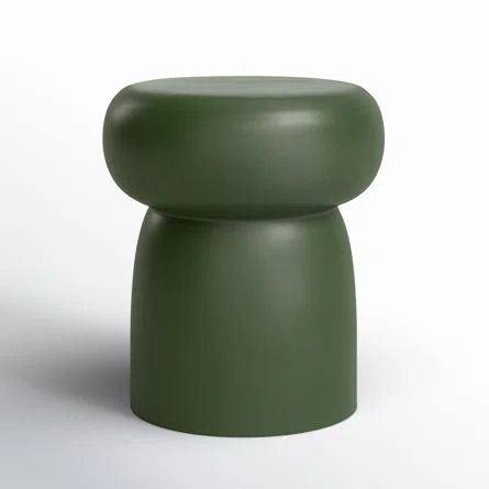 a green stool sitting on top of a white floor