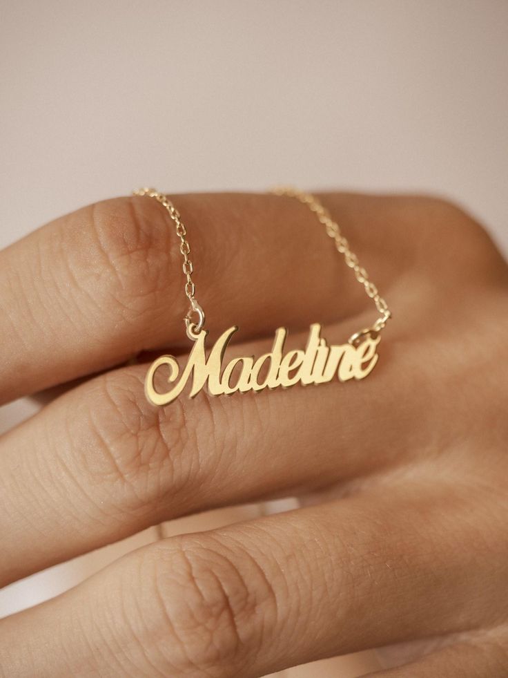 Imagine a necklace that holds a special place in your heart. Our personalized 14k gold name necklace offers a unique and meaningful way to express your love and affection. This exquisite piece, adorned with your chosen name, is a testament to the bond you share with a loved one. Whether it's a gift for your wife or a cherished keepsake for yourself, this personalized necklace is a symbol of enduring love and connection. Features and Benefits ✅ Customizable with your desired name ✅ Crafted from h Name Necklace For Anniversary Gift, Personalized Name Pendant Necklace As Gift, Personalized Name Pendant Necklace, Customized Nameplate Necklaces For Anniversary, Elegant Custom Name Jewelry For Anniversary Gift, Elegant Customized Necklaces For Anniversary Gift, Customized Yellow Gold Charm Necklaces For Personalized Gifts, Elegant Customized Name Necklace For Anniversary Gift, Elegant Customized Necklace For Anniversary Gift