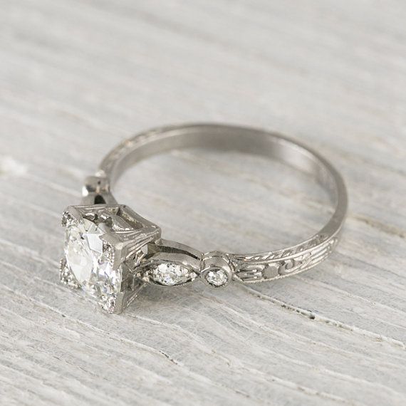 an antique style engagement ring with three diamonds